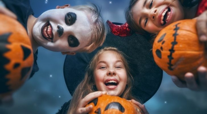Three children in Halloween costumes